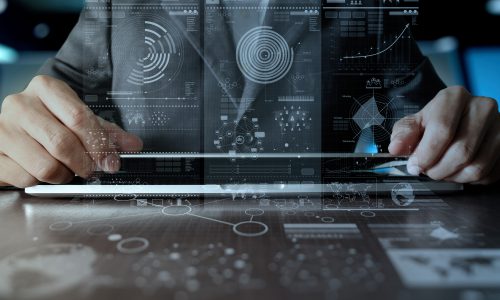 business man hand working on laptop computer with digital layer business strategy and social media diagram on wooden desk